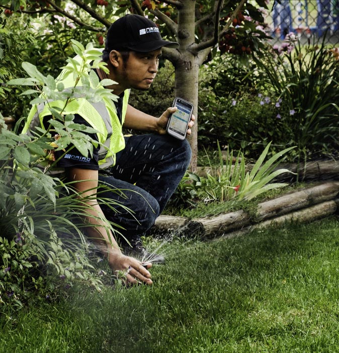 Irrigation specialist checking sprinkler performance